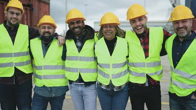 Team of diverse industrial engineers working in logistic terminal of container cargo