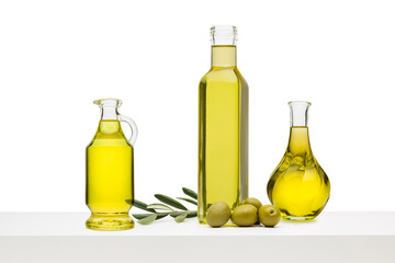 Variety olive oil bottles with green olives on white shelf