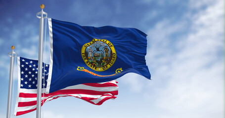 The Idaho state flag waving along with the national flag of the United States of America