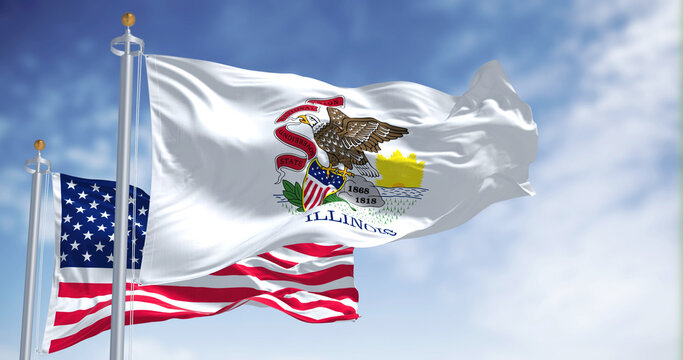 The Illinois state flag waving along with the national flag of the United States of America