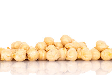 Several uncooked hummus grains, macro, isolated on white.