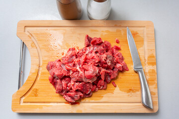 Sliced beef on a cutting board in the kitchen