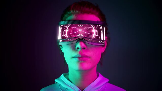 Metahuman. Beautiful young female using virtual or augmented reality glasses. High AR technologies in entertainment and education. Neon background. 3d Animation. 4K. 