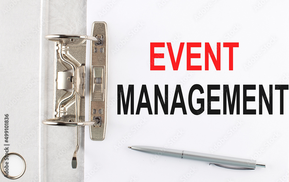 Poster event management text on the paper folder with pen. business concept
