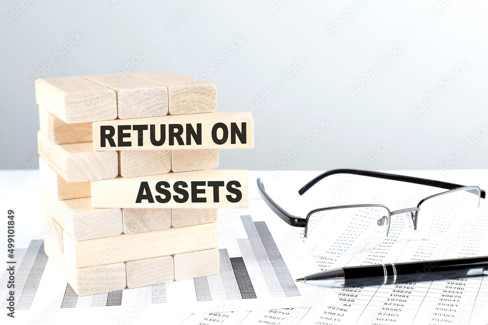 Poster return on assets is written on wooden blocks on a chart background