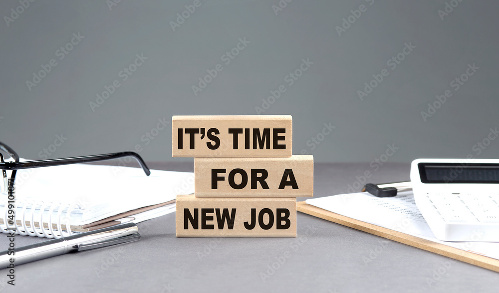 Poster it's time for a new job text on wooden block with notebook,chart and calculator, grey background