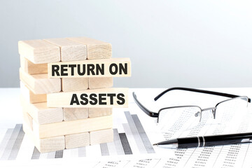 RETURN ON ASSETS is written on wooden blocks on a chart background