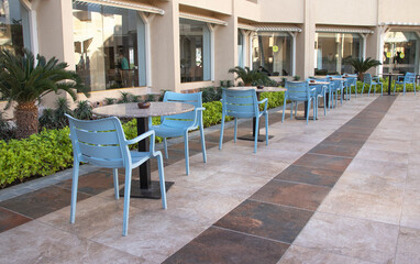 empty tables and chairs in a cafe at the hotel