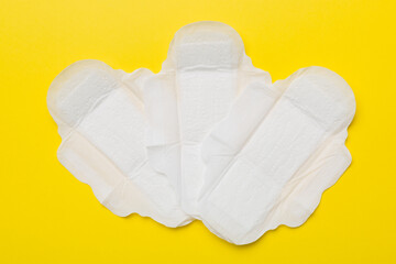 Women hygiene products or sanitary pad on colored background. Pastel color. Closeup. Empty place for text. Female daily hygiene