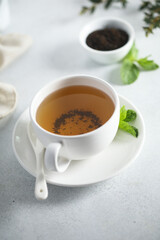 Obraz na płótnie Canvas Healthy homemade mint tea in a white cup