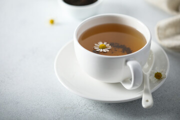 Healthy homemade chamomile tea in a white cup