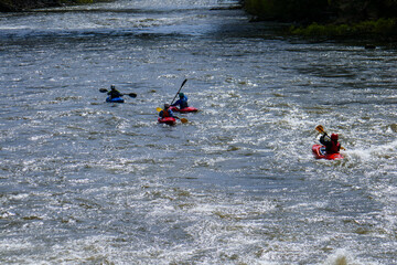Canoeing on a river in Austria. Kayaking on a river with a big current.