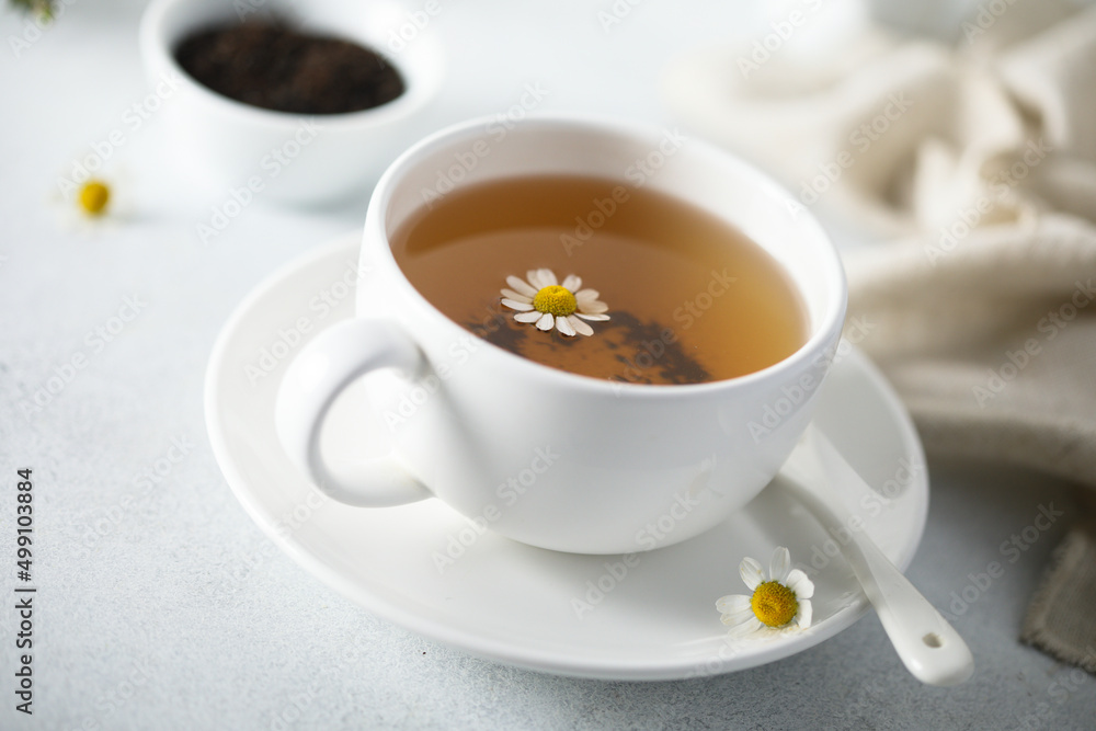 Wall mural Healthy homemade chamomile tea in a white cup