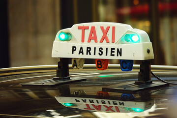 Parisian taxi sign on the top of a taxi in Paris, France
