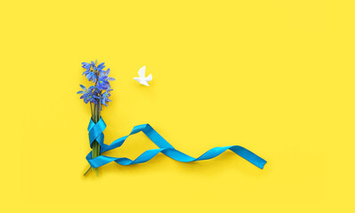 blue flowers with blue ribbon and Dove of peace on yellow background. color symbol of Ukraine flag....