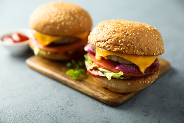 Traditional homemade cheeseburgers with pickles
