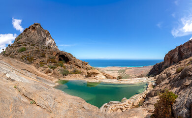 Fototapeta na wymiar Fresh water ppol high in the mountains on a sunny day. Socotra, Yemen.