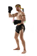 Portrait of professional thai boxer practicing isolated on white studio background. Sport, muay thai, competition, fight club concept