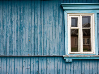 Obraz na płótnie Canvas White wooden window on a blue wooden wall, Warsaw, Poland