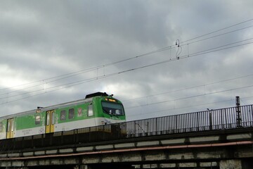 Pociąg EN57 akm kolei mazowieckich jadący przez wiadukt © Szymon