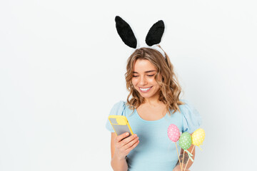Happy young woman wearing easter bunny ears