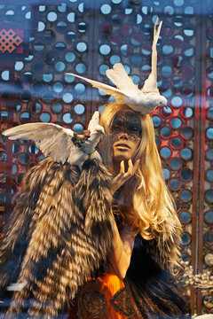 Moscow, Russia - January 04, 2012: Female mannequin in the mask and with pigeons in a fashion store of TSUM
