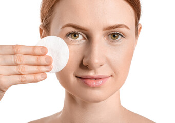 Beautiful woman with makeup sponge on white background