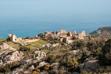 The abandoned village of Occi near Lumio in the Balagne region of Corsica with Mediterranean sea in...