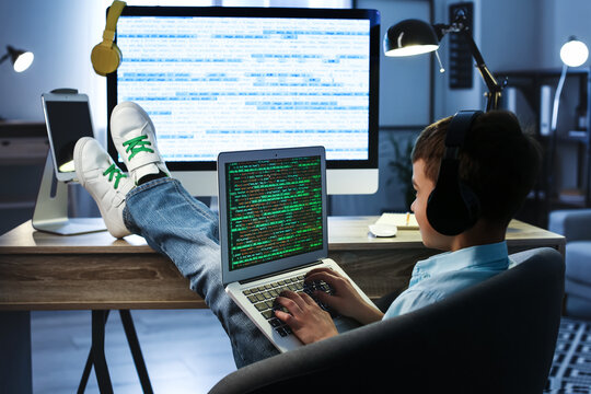 Cute little programmer using modern laptop at home