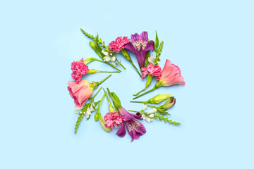 Frame made of flowers on blue background