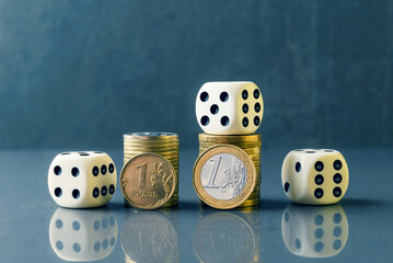 Euro and Russian rubble coins with dice. Modern economy problems concept
