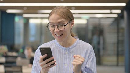 Portrait of Young Woman Celebrating on Smartphone