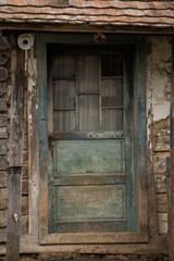 Old wooden rustic doors on rural home wall.