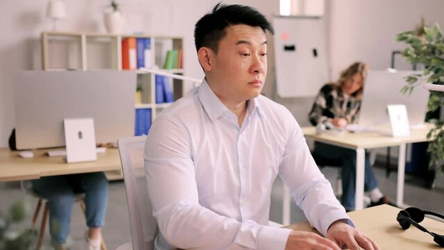 Portrait of attractive rested sleepy asian office worker which awaiking from sleep in office and continue to work. High quality 4k footage