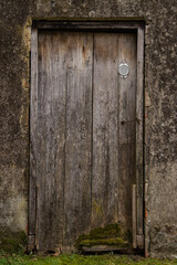 Old wooden rustic doors on rural home wall.