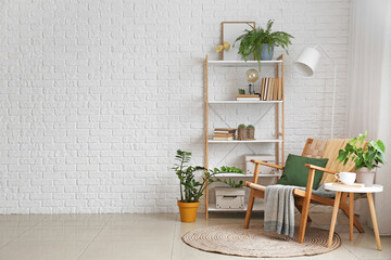 Comfortable armchair and shelf unit in living room