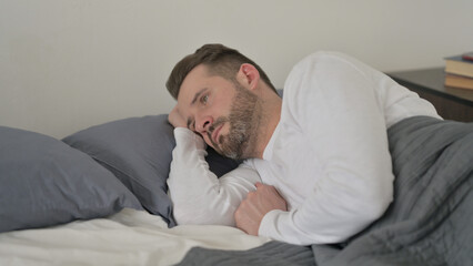Fototapeta premium Man Awake in Bed Thinking