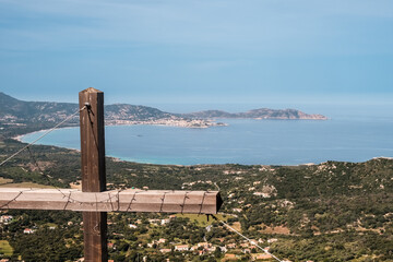 Fototapeta na wymiar View of the bay of Calvi and Revellata from a wooden cross high above the town of Lumio in the Balagne region of Corsica
