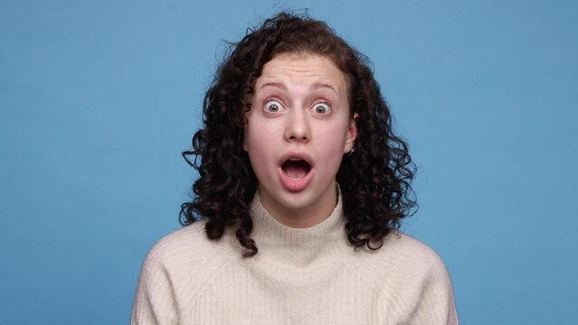 Excited beautiful girls looking at camera and saying word wow isolated on pink and blue background. 4K, video. Emotions, facial expression concept