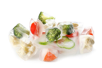 Fresh vegetables frozen in ice on white background