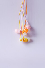 close up of colorful earphone on white background 