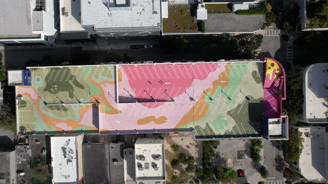 Aerial view above the museum garage rooftop parking lot in Wynwood, Miami - top down, drone shot