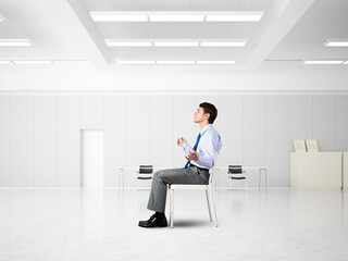 young businessman meditating in the office