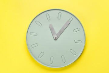 New modern clock on yellow background