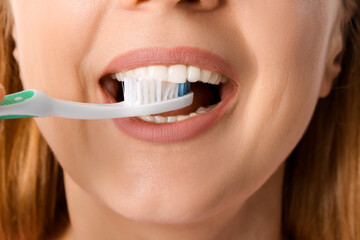 Beautiful mature woman brushing teeth, closeup