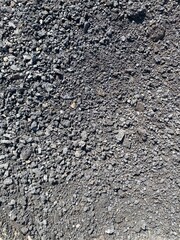 Background texture: black asphalt granulate road surface. Dark gray floor, asphalt pavement. Car track for cars