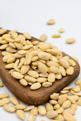 Peeled almond kernel isolated on white background. A bowl of almonds. close up