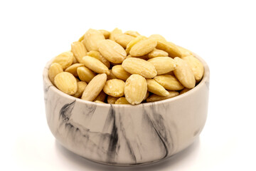 Peeled almond kernel isolated on white background. A bowl of almonds. close up