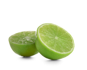 Halves of fresh juicy limes on white background