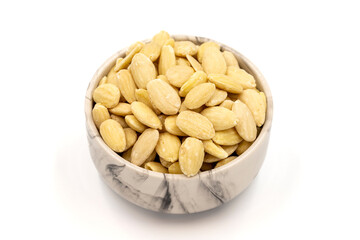 Peeled almond kernel isolated on white background. A bowl of almonds. close up